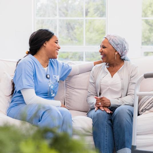 cancer patient on couch with her doctor after her radiation therapy cancer patient on couch with her doctor after her radiation therapy