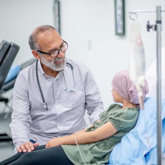 Cancer patient in the hospital with her doctor during immunotherapy Cancer patient in the hospital with her doctor during immunotherapy