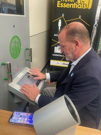 Man using Higi health station to obtain biometric information like blood preasure