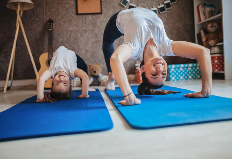 Mom and daughter doing yoga