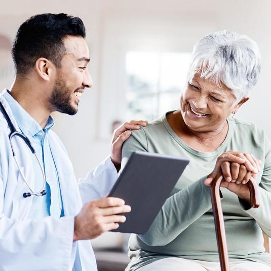 A doctor reviewing medical records with a patient A doctor reviewing medical records with a patient