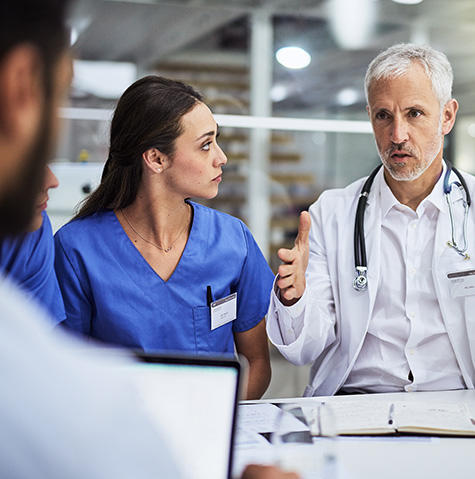 A doctor speaking with colleagues A doctor speaking with colleagues