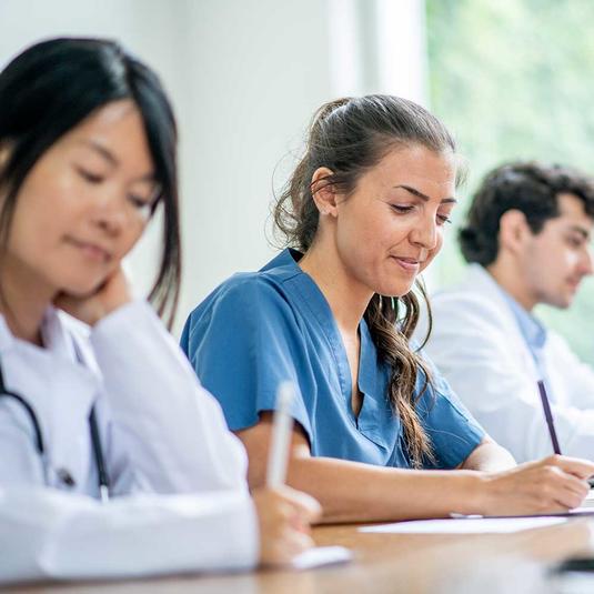 Nurses learning in a  classroom setting Nurses learning in a  classroom setting