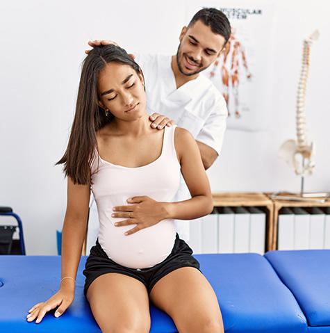 Pregnant woman with her physical therapist Pregnant woman with her physical therapist