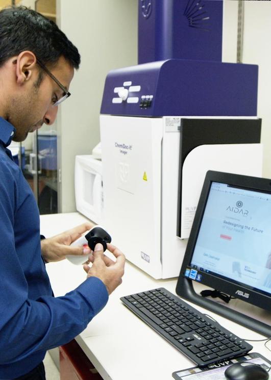 A man examining a custom created lab device