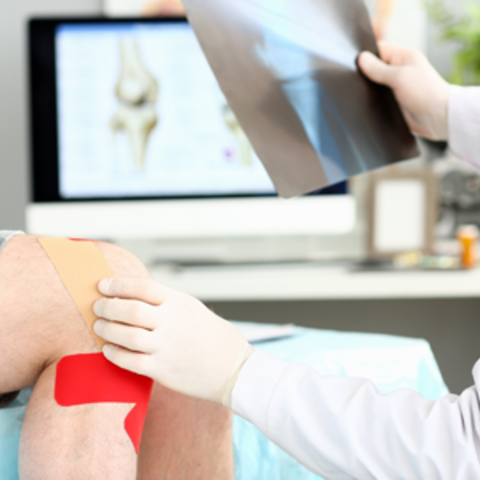 A doctor examining a knee
