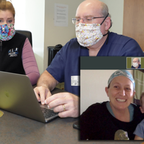 Two doctors conducting a telemedicine visit with a parent and child